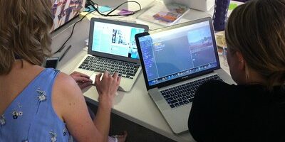 Two teachers working in visual programming environments